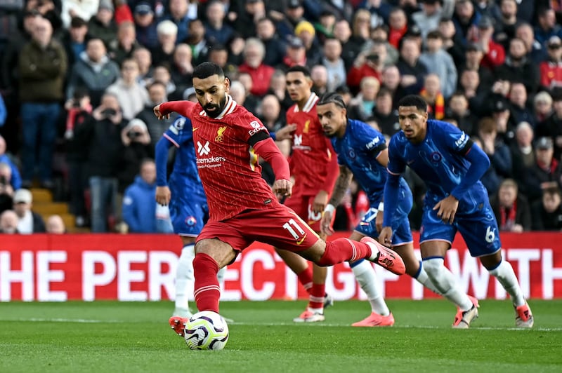 Liverpool's Mohamed Salah shoots from the penalty spot to score the team's first goal against Chelsea. Photograph: Paul Ellis/AFP/Getty Images